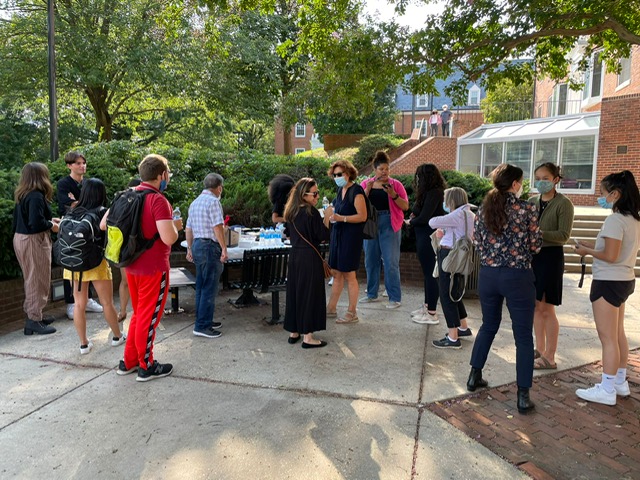 a group of students and faculty gather outside of St. Mary's Hall patio area